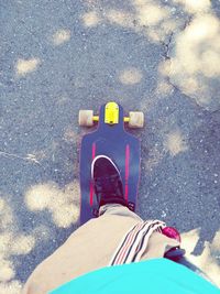 Low section of man standing on road