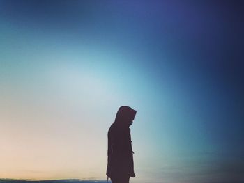 Silhouette of man standing against clear sky