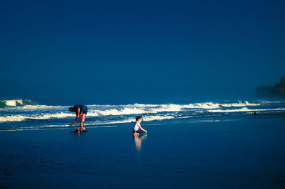 People on beach against sky