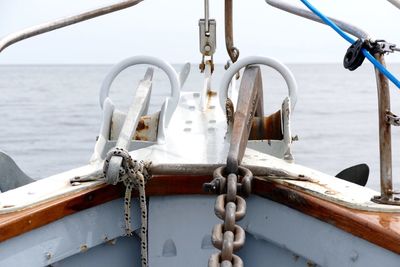 Close-up of sailboat sailing on sea against sky