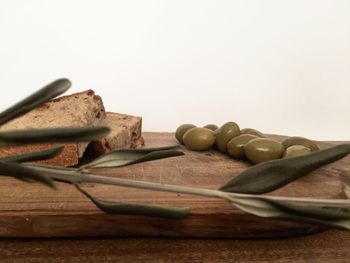 Close-up of bread on table against white background