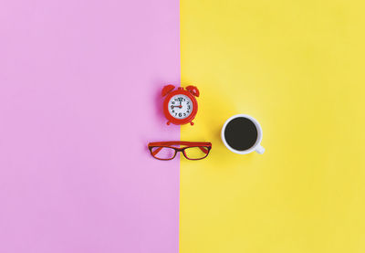 Yellow and coffee cup against wall