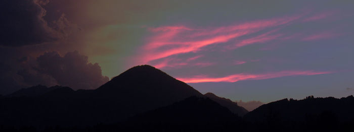 Scenic view of mountains against cloudy sky