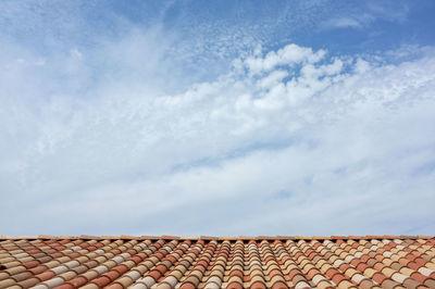 Low angle view of building roof against sky