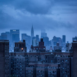 Cityscape against cloudy sky