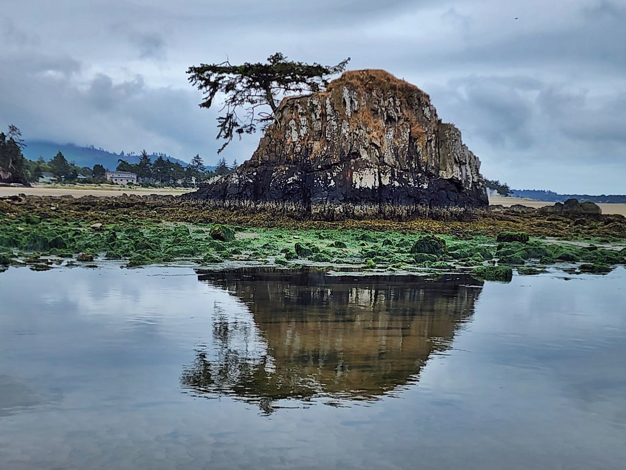 water, reflection, sky, landscape, cloud, nature, environment, rock, travel destinations, scenics - nature, beauty in nature, land, sea, travel, shore, coast, mountain, tranquility, tourism, no people, beach, rock formation, outdoors, tranquil scene, non-urban scene, bay, lagoon, body of water, tree, overcast, cliff, animal wildlife, terrain, trip, holiday, architecture