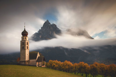 Scenic view of mountains and buildings against sky