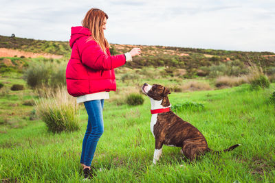 Woman with dog on grass