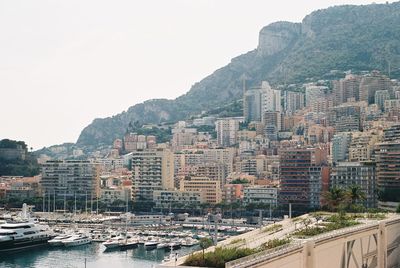 Buildings in city against clear sky