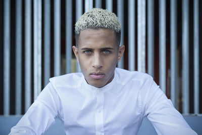 Portrait of a young man with a metallic background