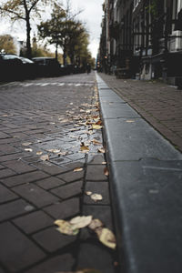 Surface level of footpath amidst buildings in city