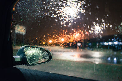 Close-up of rain drops on car window