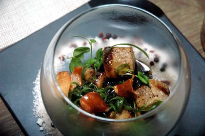 High angle view of wagyu beef cubes in glass bowl on table