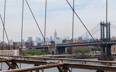 Steel cables of bridge with buildings in backgrounds