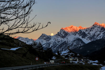 Scenic view of snowcapped mountains against sky during sunset