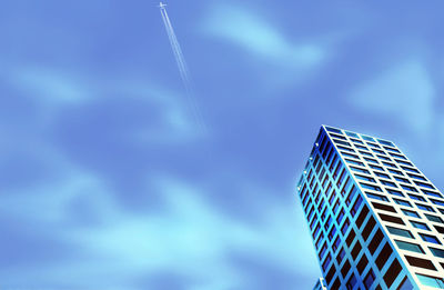 Low angle view of modern building against blue sky