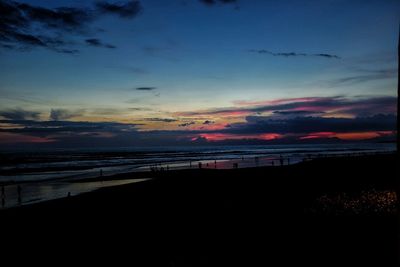 Scenic view of beach against sky during sunset