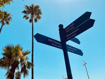 Low angle view of road sign against sky