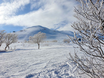 Scenic view of snow covered mountains against sky