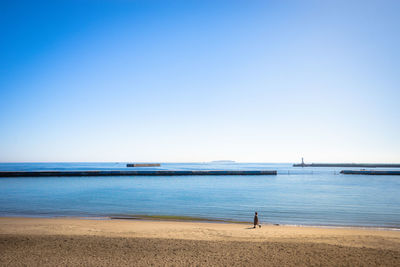 Scenic view of sea against clear blue sky