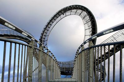 Low angle view of bridge against cloudy sky