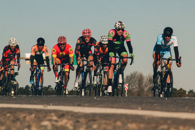 People riding bicycles on road