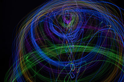 Light painting abstract colorful irregular lines or patterns on black background with long exposure.