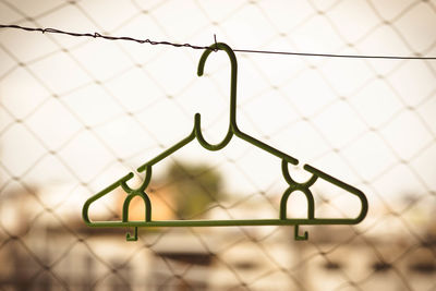 Close-up of chainlink fence with hanger
