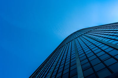 Low angle view of modern building against clear blue sky