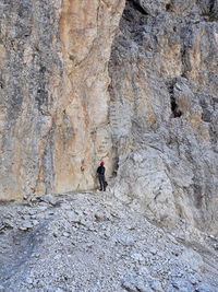 Rear view of man walking on rock