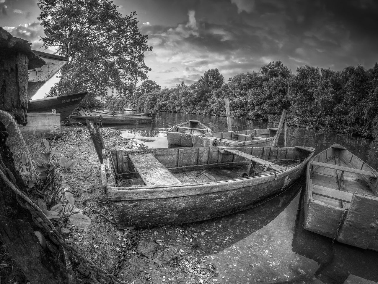 ABANDONED BOAT MOORED IN WATER