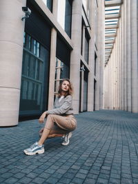 Portrait of woman on building in city