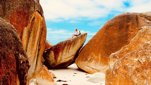 Close-up of rock formation on beach against sky