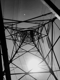 Low angle view of electricity pylon against sky