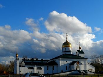 Low angle view of church against cloudy sky