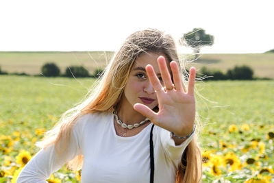 Portrait of a beautiful young woman on field