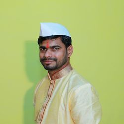 Portrait of young man against gray background