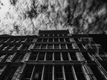 Low angle view of building against cloudy sky