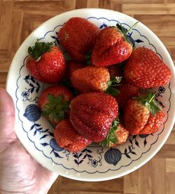 High angle view of strawberries in plate on table