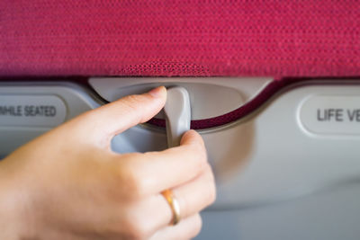 Cropped hand of woman adjusting vehicle seat