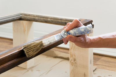 Close-up of hand working on wood