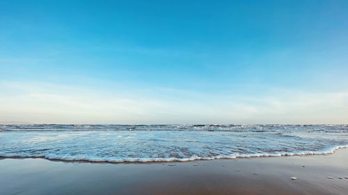 Scenic view of sea against blue sky