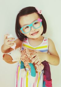 Close-up portrait of happy girl playing with tattoo