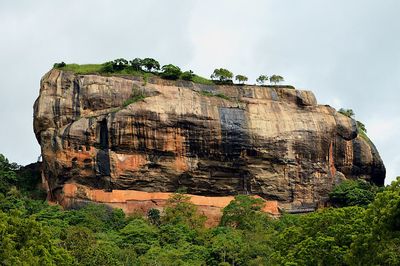 Low angle view of rock formations against sky