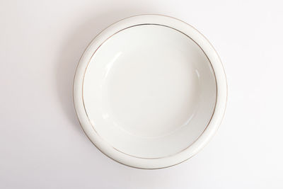 Directly above shot of empty bowl against white background