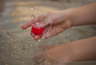 Close-up of woman hand in water