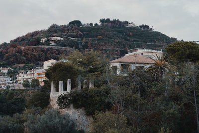 Buildings in town against sky