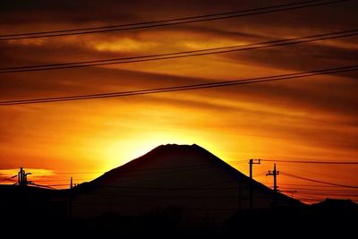 Silhouette of power lines at sunset