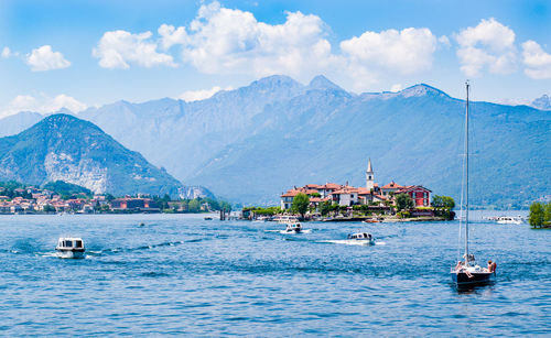 Scenic view of sea and mountains against sky