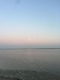 Scenic view of sea against clear sky during sunset